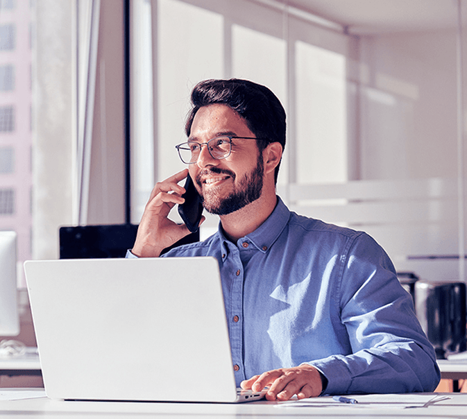 Man on phone with laptop